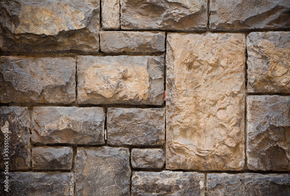 Fototapeta premium Different size brick masonry. Close up shot. Abstract texture or background.