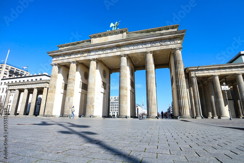Brandenburg Gate in Berlin  usually a major landmark and tourist hotspot  is mostly deserted during Coronavirus lockdown in Germany.