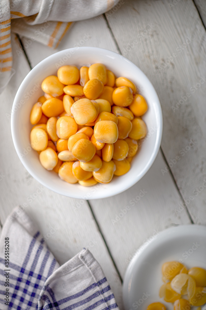 Lupins in a Bowl on a White Wooden Table with Napkins Lupins in a Bowl on a White Wooden Table with Napkins