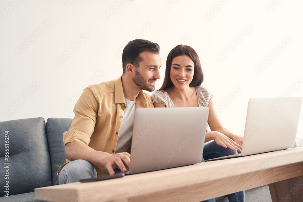Young man and woman helping each other at remote working Young man and woman helping each other at remote working