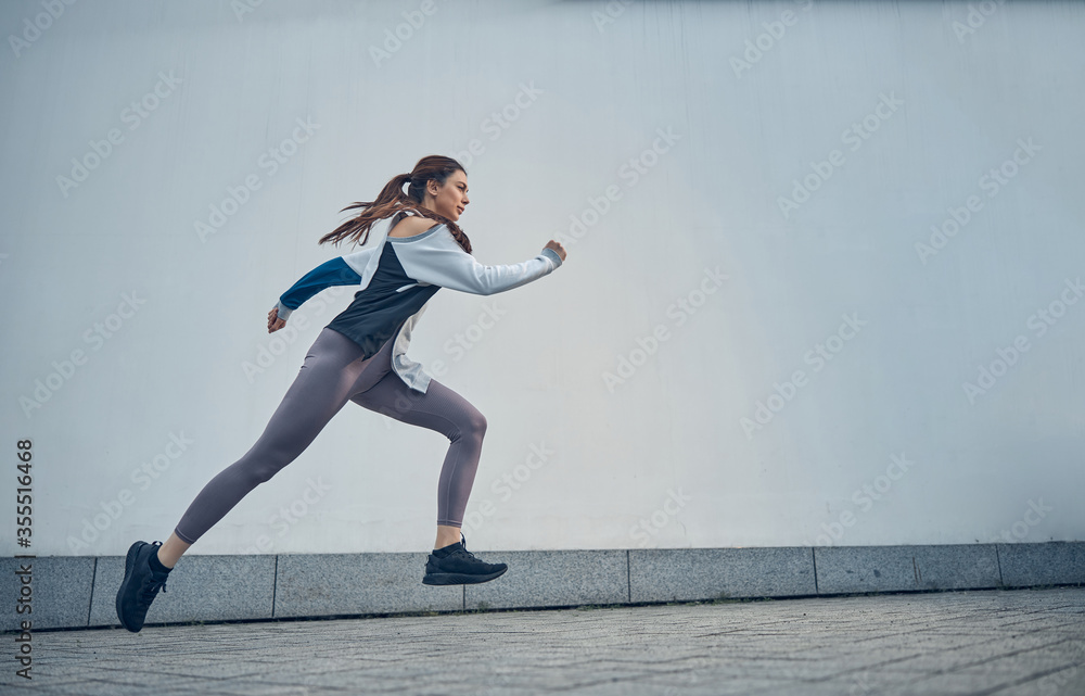 Active young Caucasian woman captured in motion