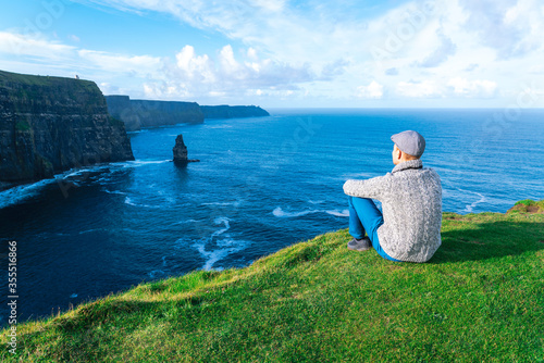 Obraz na plátně Man looking at cliffs of moher in Ireland
