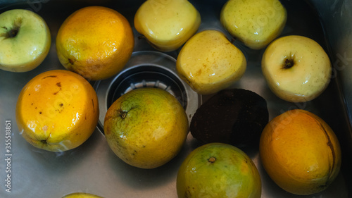 Photograph of a set of fruits that are being washed