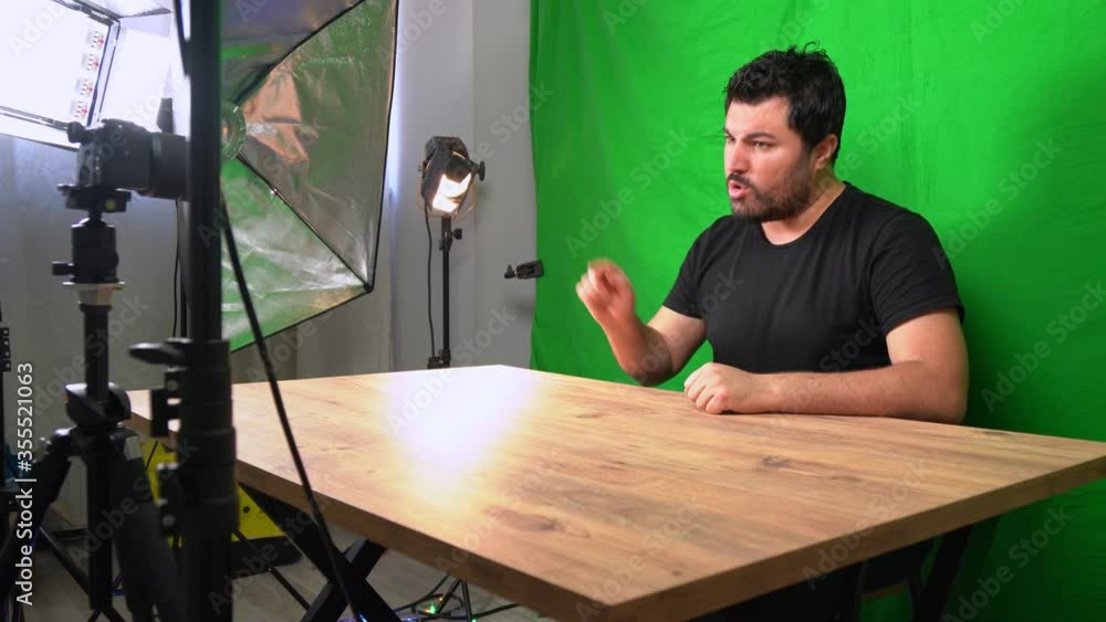 Vlogger man recording youtube video in home green screen studio with camera Vlogger man recording youtube video in home green screen studio with camera