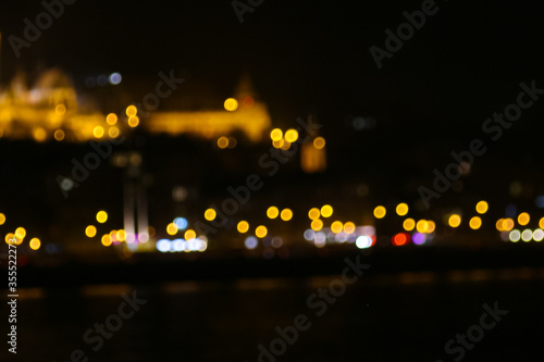 Bokey city lights, traffic lights at night with defocused castle, seen in Budapest, capital of Hungary.  © Sybille