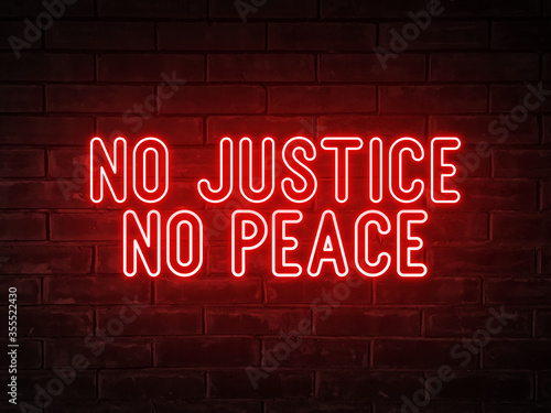 No justice, no peace - red neon light word on brick wall background