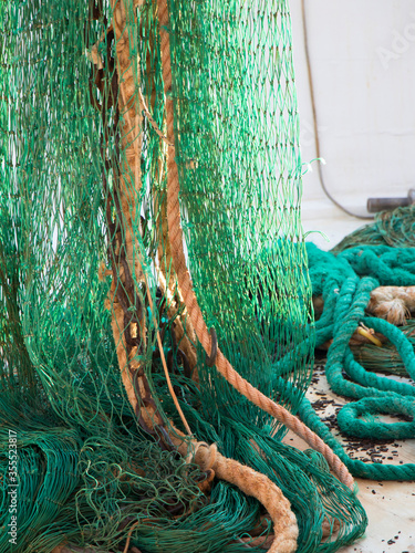 Fotografija Green fishing trawl net in a trawler boat