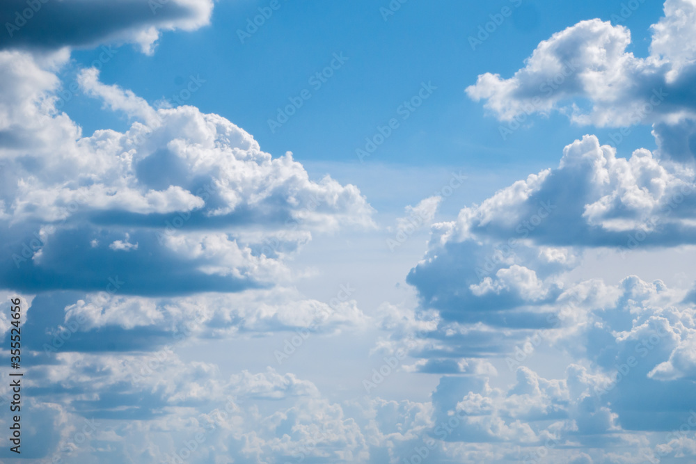 Beautiful blue sky with big fluffy clouds. The horizon is covered with gray haze. Beautiful blue sky with big fluffy clouds. The horizon is covered with gray haze.
