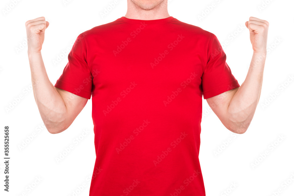 Front view of confident man in red t-shirt showing power gesture isolated Front view of confident man in red t-shirt showing power gesture isolated