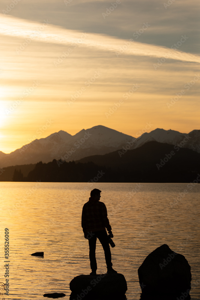 silhouette of a man taking a photo at a perfect sunset in Patagonia Argentina