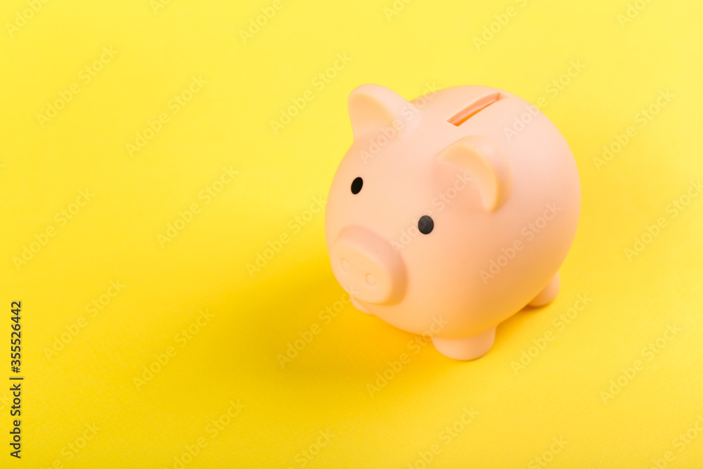 pink piggy bank on a yellow background. Concept of saving money or savings, investment. pink piggy bank on a yellow background. Concept of saving money or savings, investment.