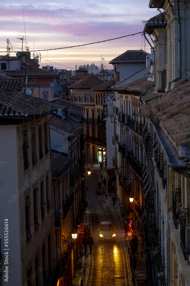 Scenic rooftop view of a quiet neighborhood street at dusk in Granada, Spain