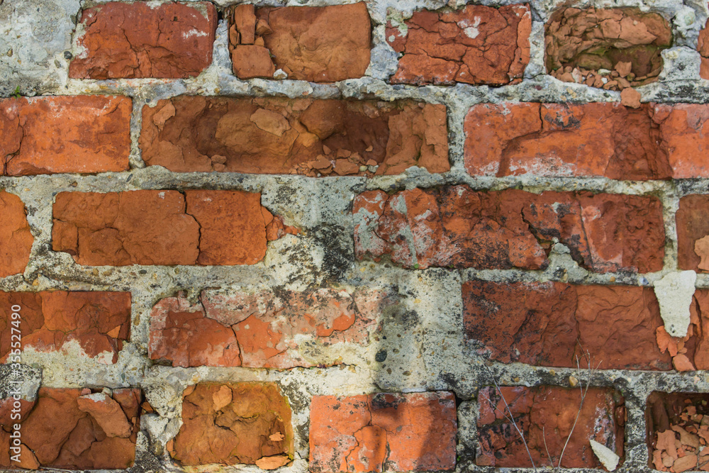 Fototapeta premium Red brick wall background. Old and broken brick.