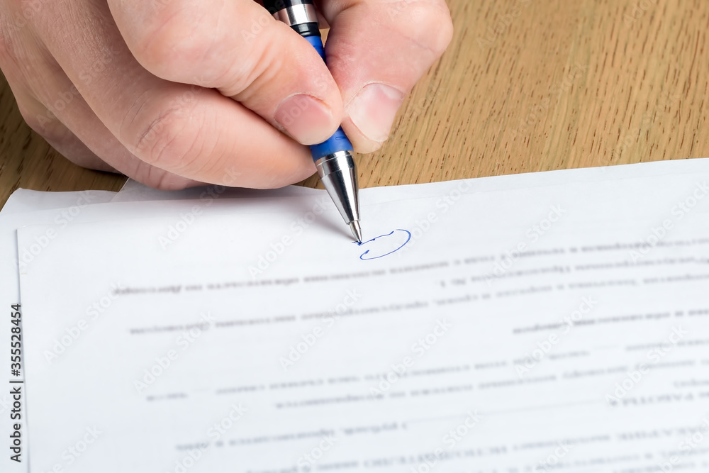 Man's hand signs a contract. Agreement, deal, business concept. Man's hand signs a contract. Agreement, deal, business concept.