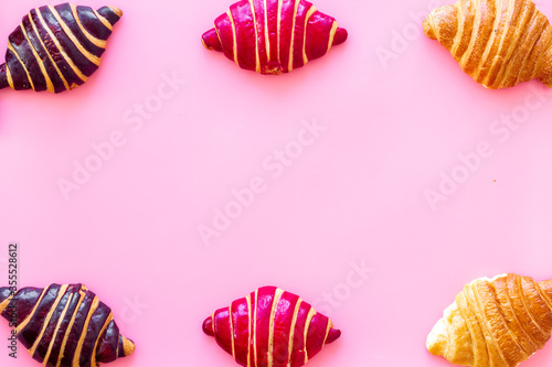 Frame of croissants - fresh bakery on pink background. Top view © 279photo