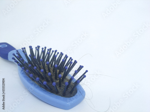 blue hairbrush with strands of hair 