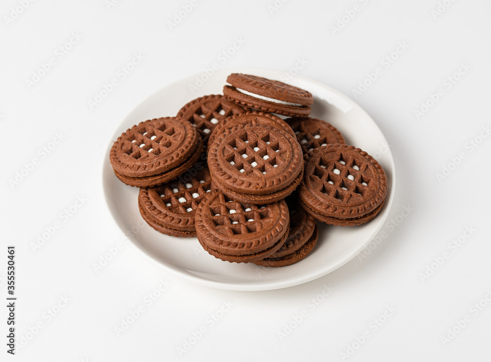 Macro photo of chocolate cookies with filling on a white background. Isolate, close up Macro photo of chocolate cookies with filling on a white background. Isolate, close up