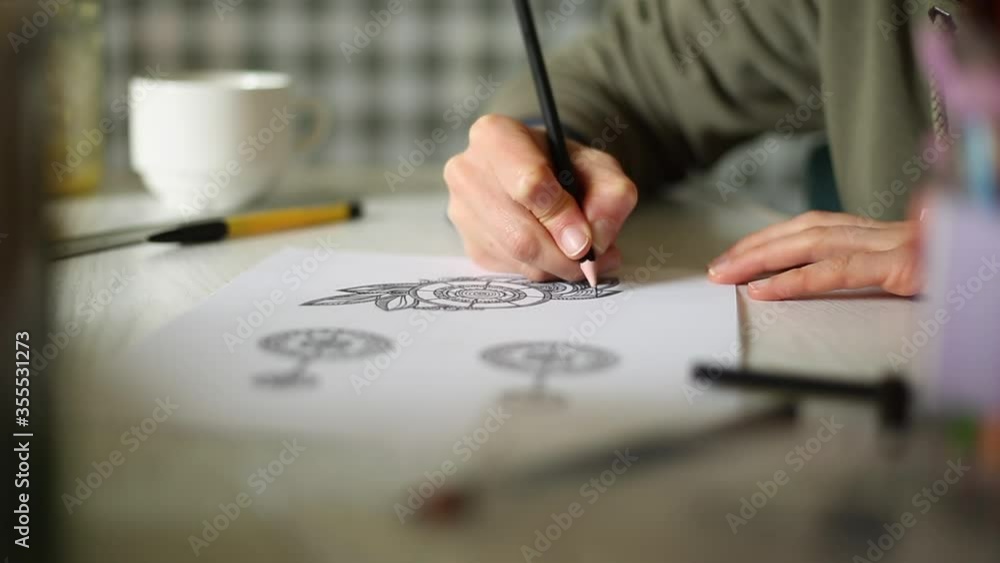 Woman designer draws a sketch for jewelry. Woman designer draws a sketch for jewelry.