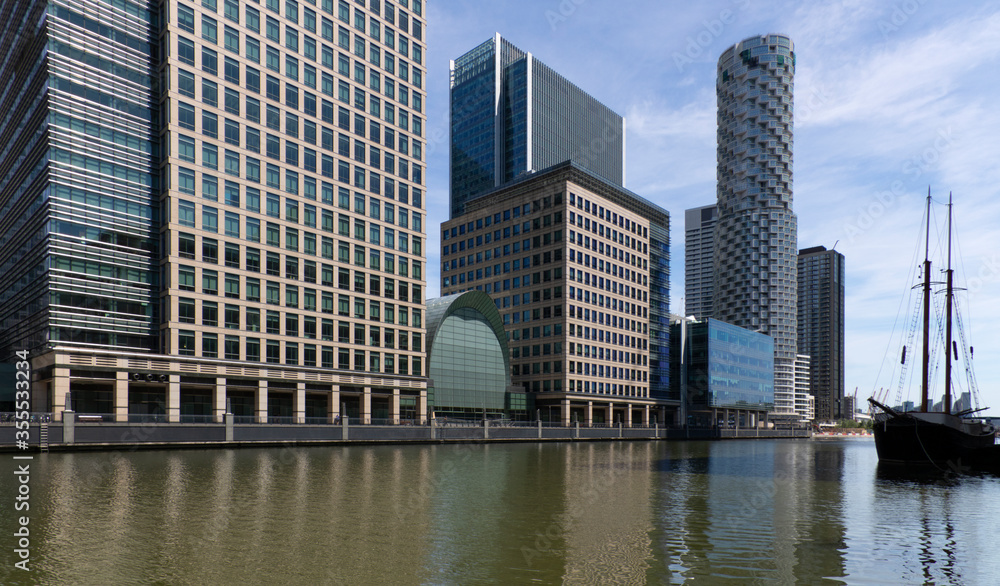 A view of the modern Canary Wharf skyline in old Victorian docks on Isle of Dogs, London, United Kingdom.
