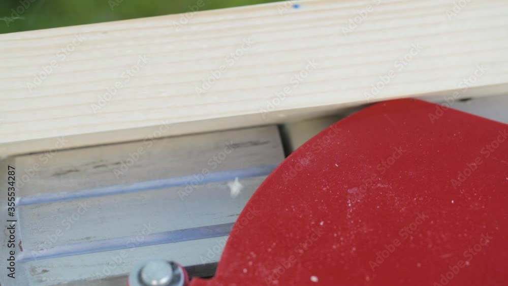 Professional carpenter planing wood with a planer. Men working in home workshop. Woodworking tool in carpenter's shop. Heavy hand made craftsman by the production furniture. Joiner equipment. Professional carpenter planing wood with a planer. Men working in home workshop. Woodworking tool in carpenter's shop. Heavy hand made craftsman by the production furniture. Joiner equipment.