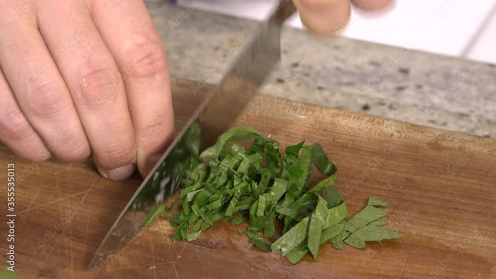 Professional chef chopping parsley leaves. Professional chef chopping parsley leaves.