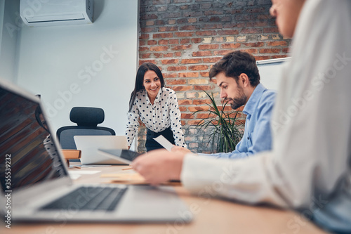 Fotografía Workers discussing presentation of business project with boss in office