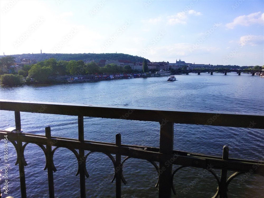 View of the Vltava river and Prague from a high metal bridge View of the Vltava river and Prague from a high metal bridge