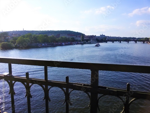 View of the Vltava river and Prague from a high metal bridge