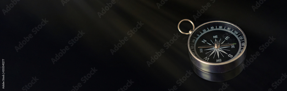 Banner of compass on dark black background with copy space using as direction