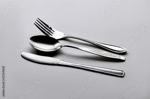 Isolate metallic cutlery set side look in Grey background