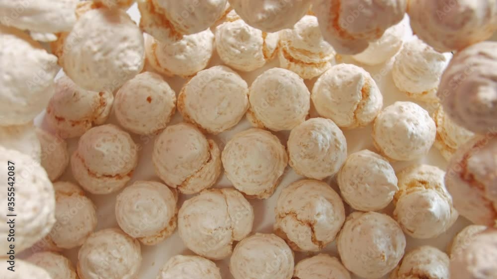 The meringues sweets light pink peach colour fast counterclockwise rotation table top still life The meringues sweets light pink peach colour fast counterclockwise rotation table top still life