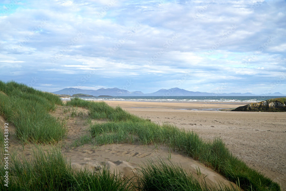 The beach at Aberffraw with the mountains of Snowdonia National Park in the distance