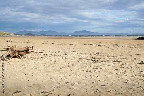 The beach at Aberffraw with the mountains of Snowdonia National Park in the distance