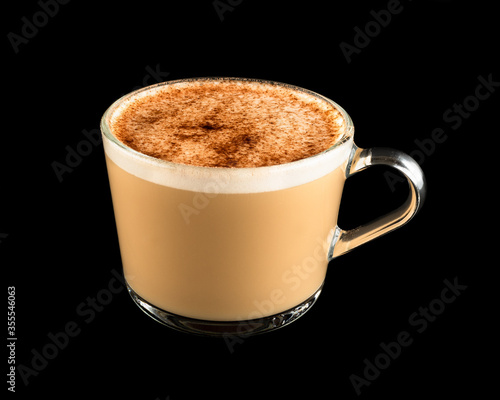 Cappuccino in a glass mug isolated on a black background