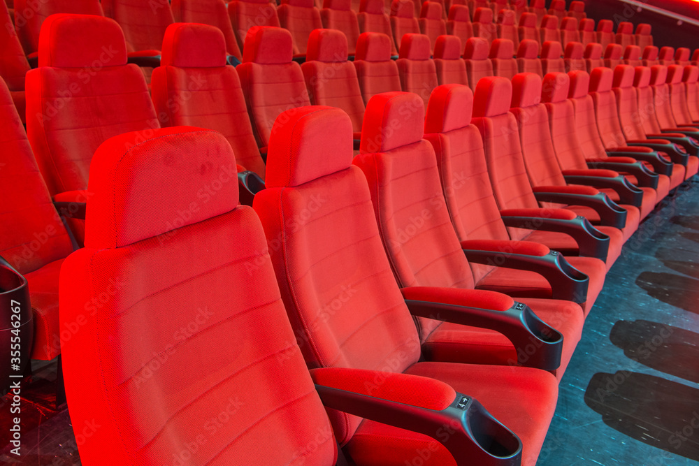 Fototapeta premium Rows of red empty red seats in a movie theatre.