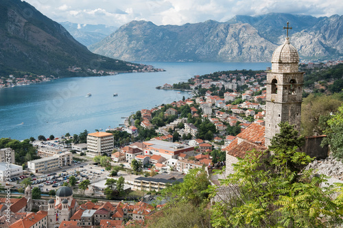 Beautiful views of the city of Kotor and the Bay of Kotor. Church of Our Lady of Remedy. City in front and mountains in the back of the photo.