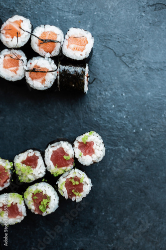 Salmon rolls and tuna rolls on a black background
