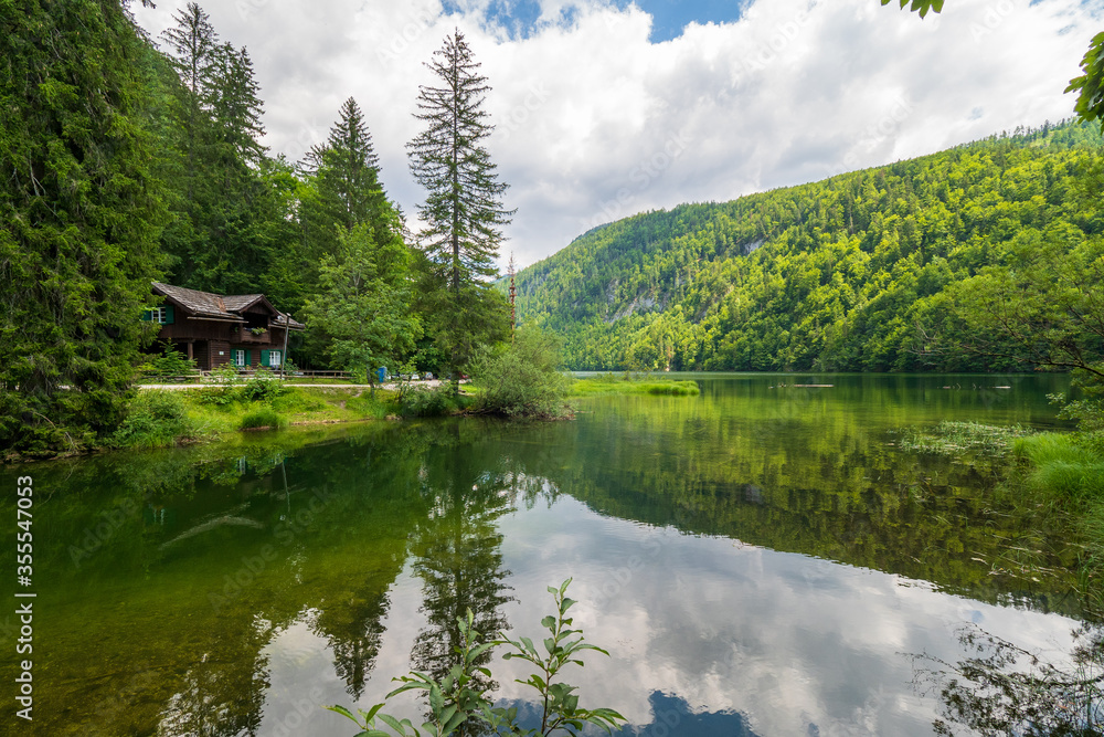 Fototapeta premium Old wooden forester's lodge at the lakeshore of the legendary Lake Toplitz, Ausseer Land region, Styria, Austria