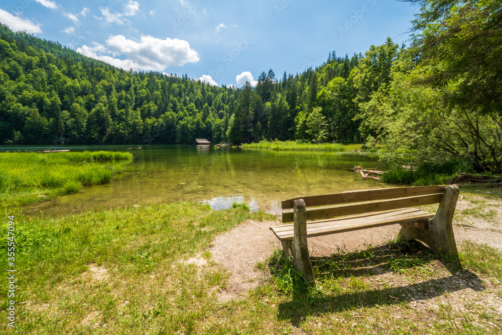 Empty bench inviting hikers to sit down and enjoy the view and tranquility around the legendary Lake Toplitz, Ausseer Land region, Styria, Austria