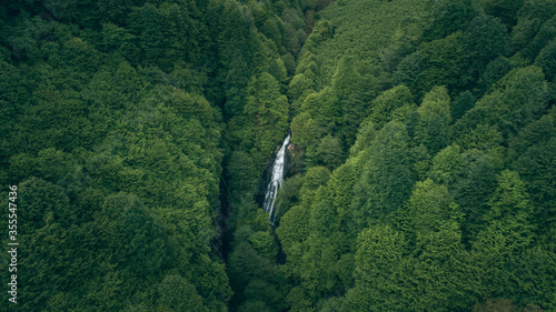waterfall in the middle of the forest which is seen from above using a drone camera. Aerial landscape of tourism destinations in turkey and Ordu. Outdoor drone travel of hiding place