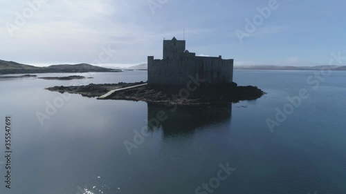Isle of Barra, Scotland. Outer Hebrides. Scotland. Epic aerial drone video footage of Kisimul Castle, medieval castle located by Castlebay