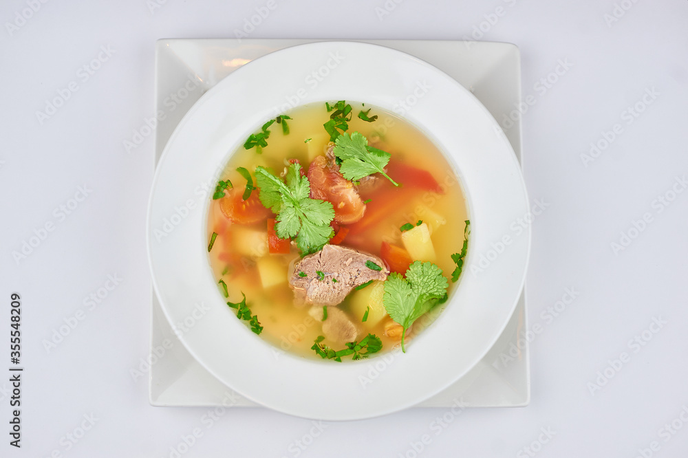 soup with meat, pepper, tomatoes, greens on a white background soup with meat, pepper, tomatoes, greens on a white background