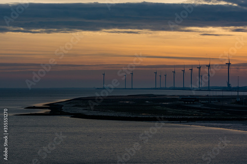 Wind electricity on the coast at night in Delfzijl, Netherlands