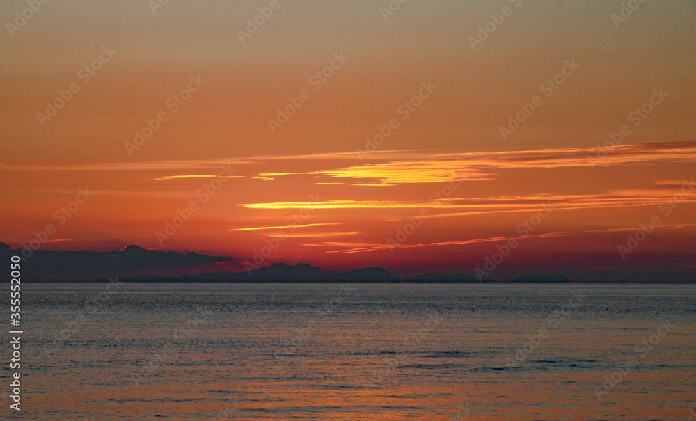A perfect golden sunset over a calm sea