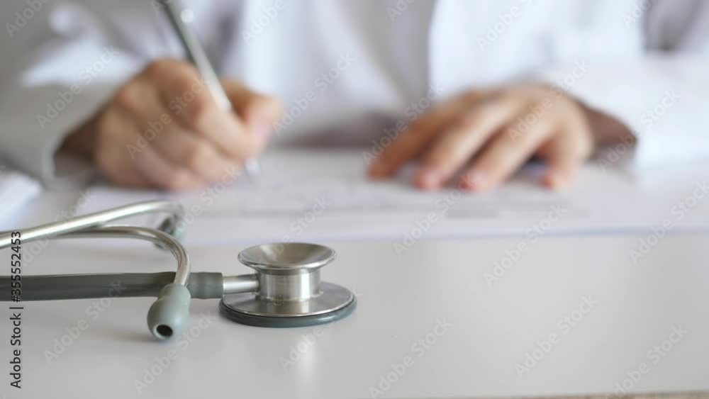 doctor works working at desk, hands of doctor panning shot doctor works working at desk, hands of doctor panning shot