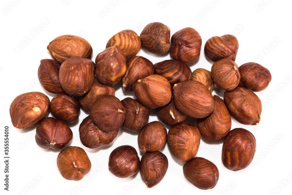 Portion of hazelnuts on a white background Portion of hazelnuts on a white background