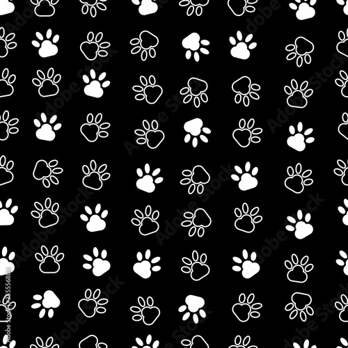 Seamless vector illustration. Modern art of dog’s paws. black background.