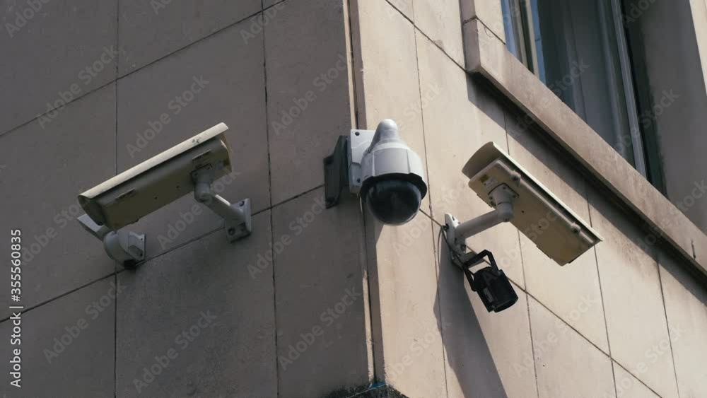 Surveillance cameras on the building covering three different corners. Surveillance cameras on the building covering three different corners.