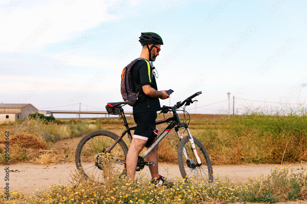 cyclist looking at his smartphone cyclist looking at his smartphone
