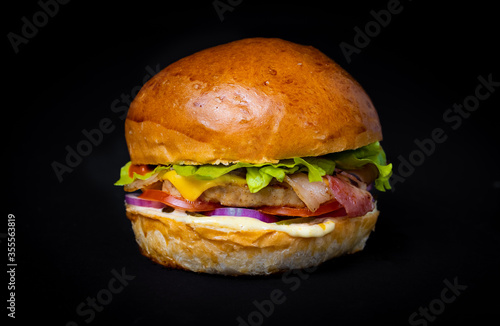 fresh tasty burger on a black background